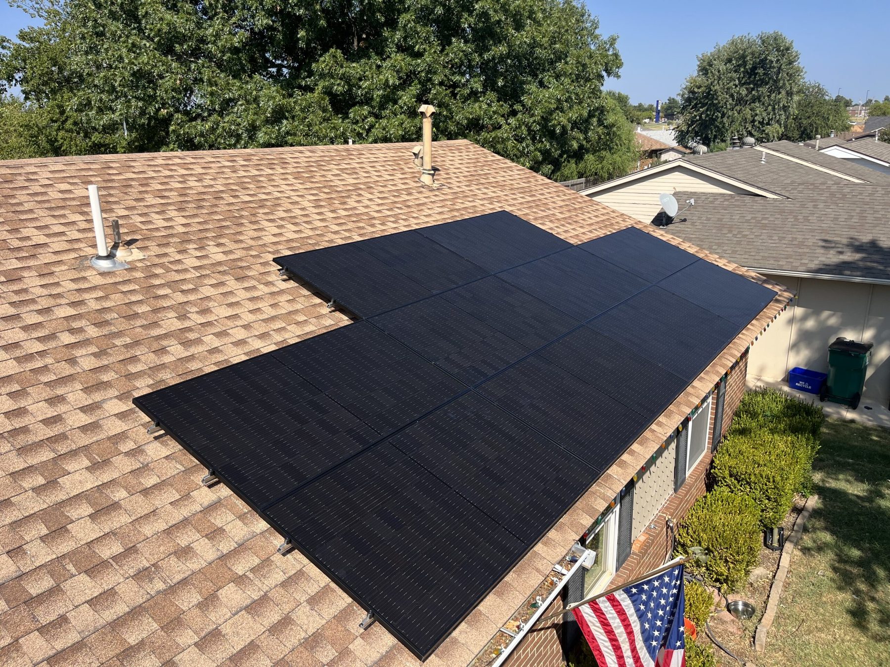Black solar panel array on a shingle roof in the Oklahoma City metro