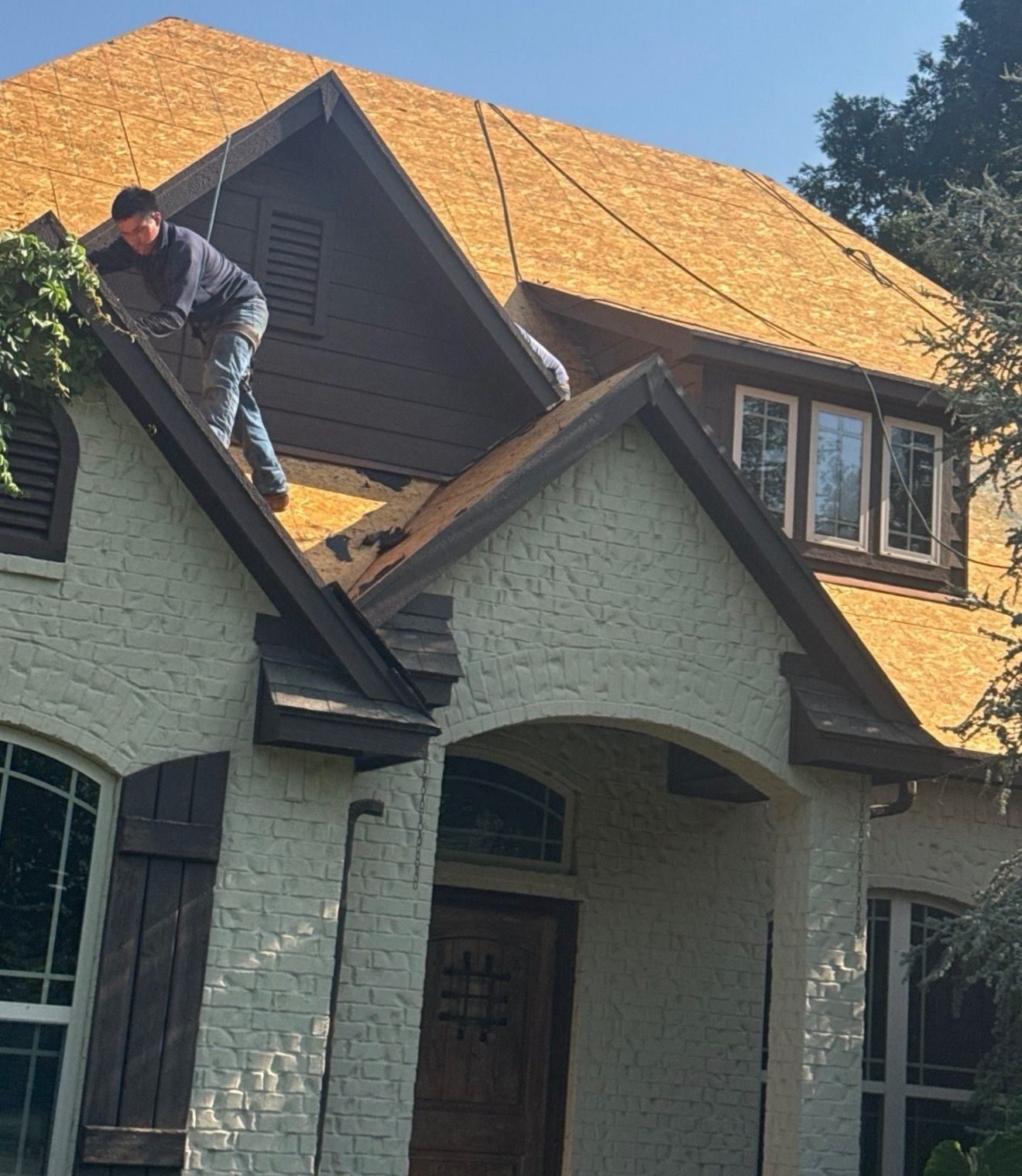CRE Roofing crew installing new decking and underlayment on an Oklahoma home